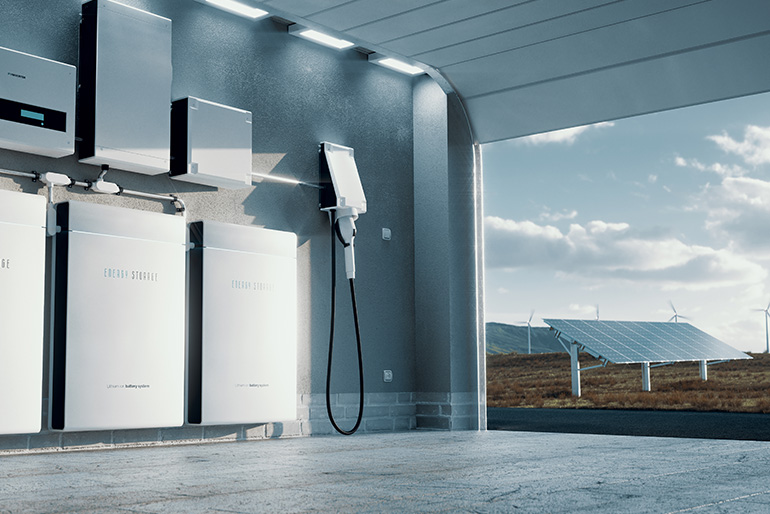 Garage with energy storage system on wall and solar panels visible in distance