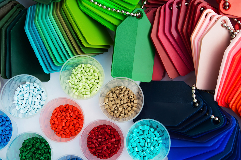 several containers and swatches of colored plastic and resin material
