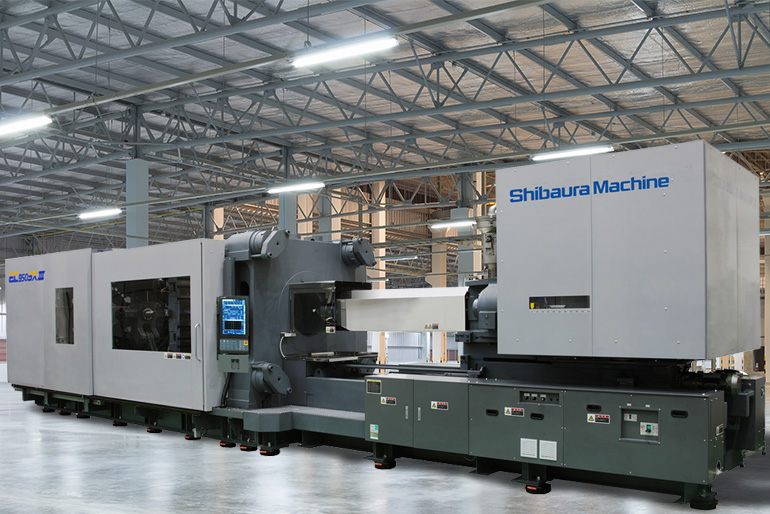 Large plastic injection molding machine in an industrial setting