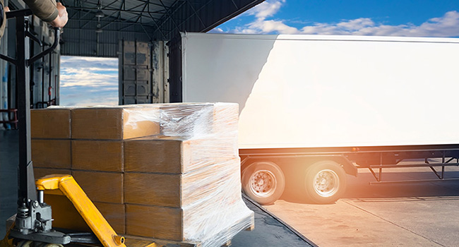 Truck backing up to cargo bay of a warehouse